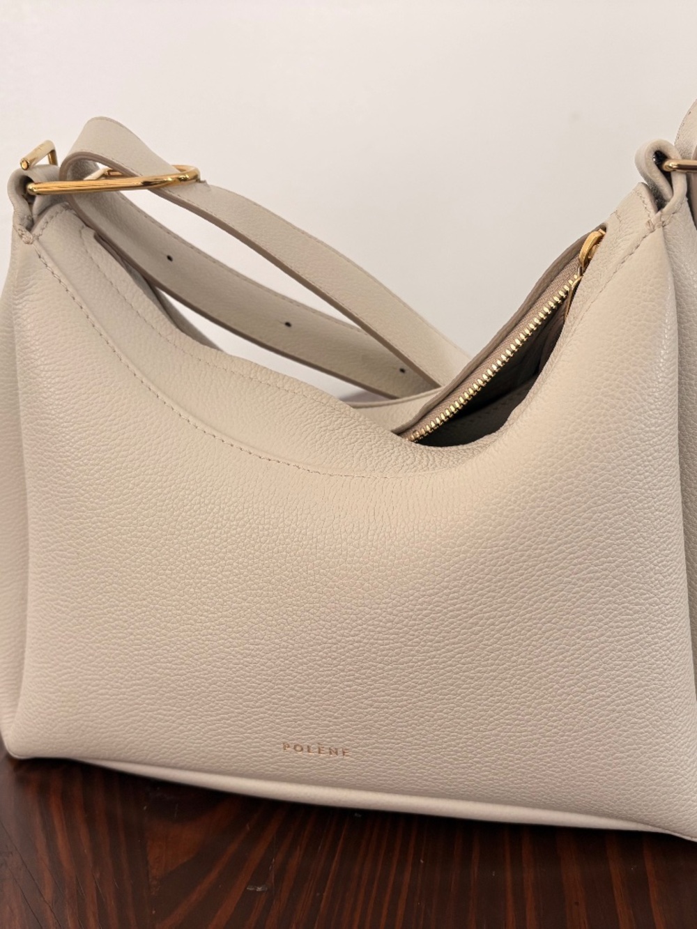 Chic cream shoulder bag by Polene. Smooth leather finish. Ideal for everyday use